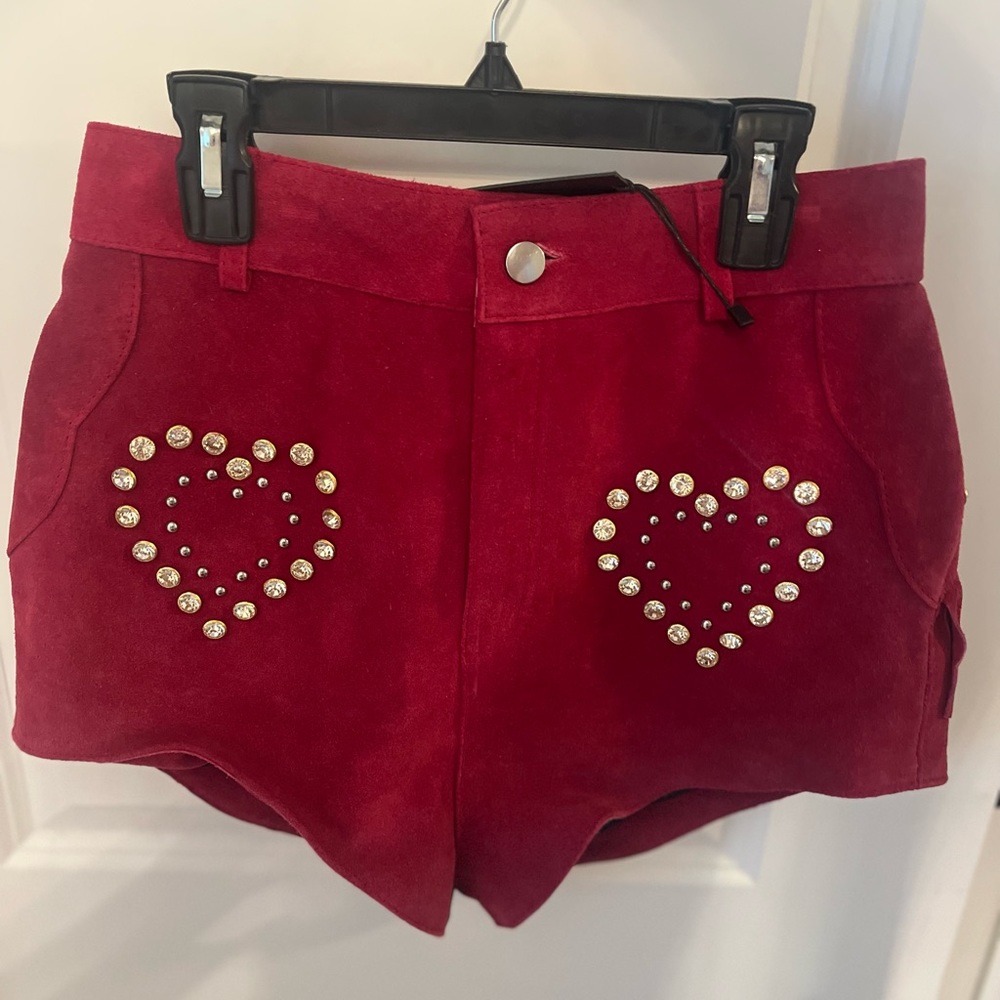 Rhinestone cowgirl red leather shorts with fringe trim on back. Never worn